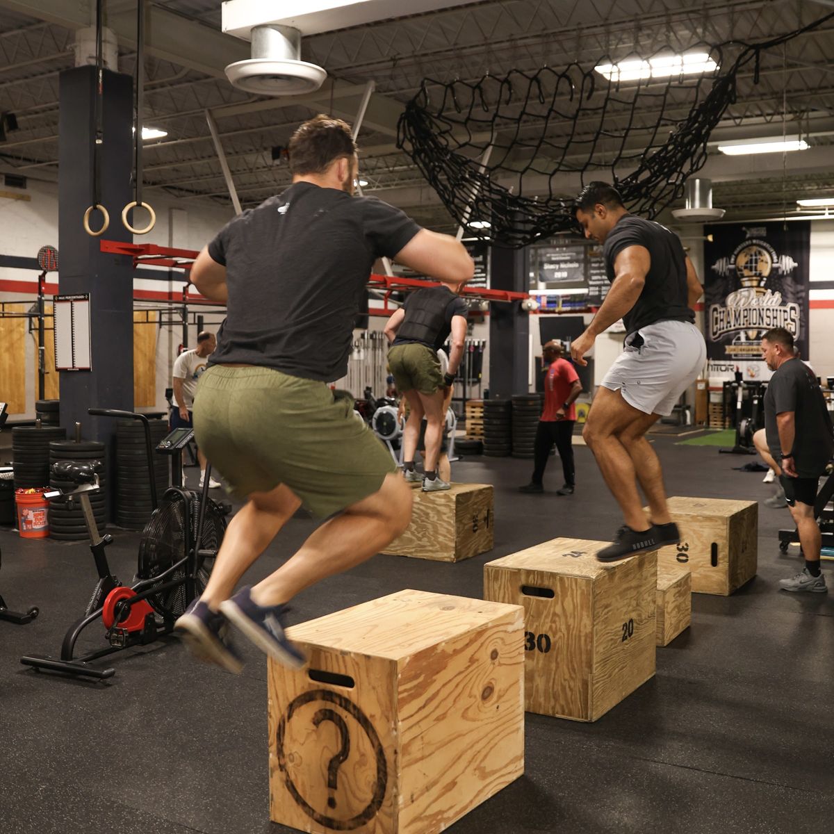 Two men mid box jump