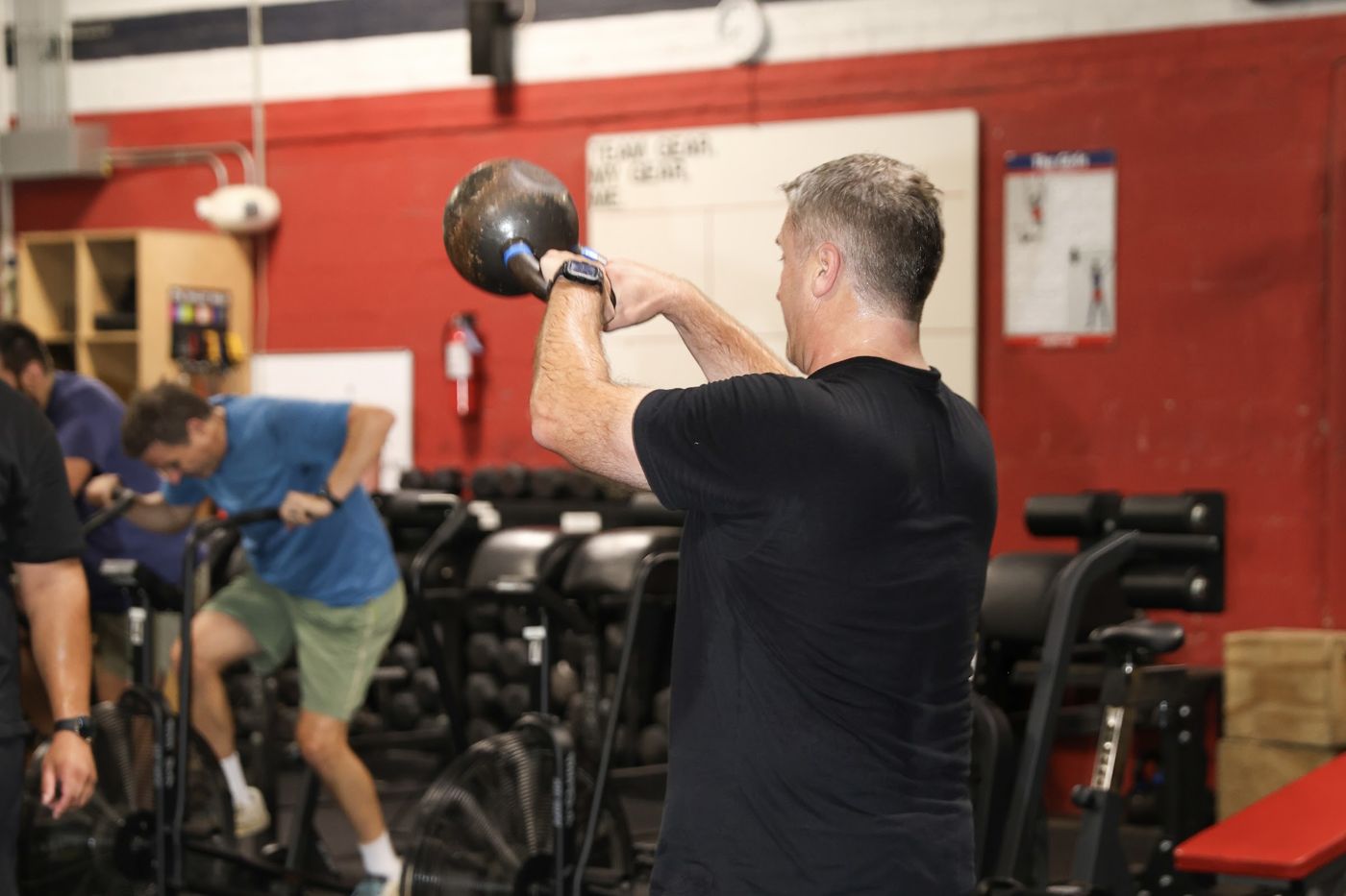 A man mid kettlebell swing