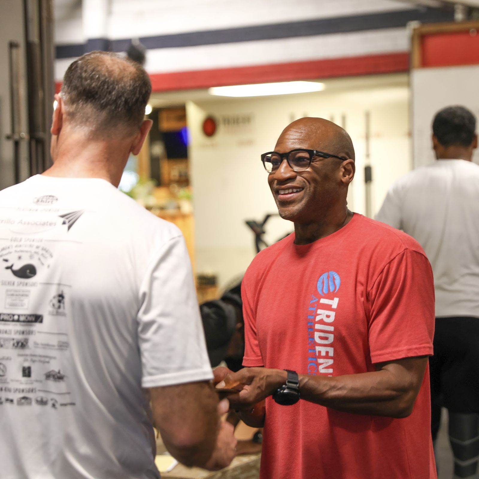 Chriss Smith Jr. laughing with a member after the first Saturday Standard
